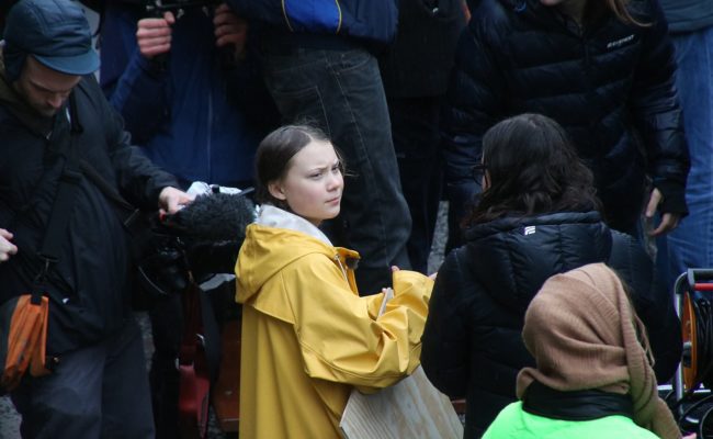 picture of greta thunberg in a crowd.